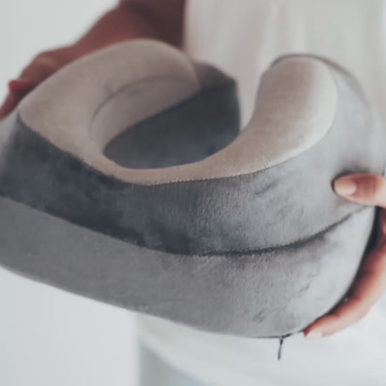 Squeezing the pillow to show how buttery soft the fabric and memory foam are.